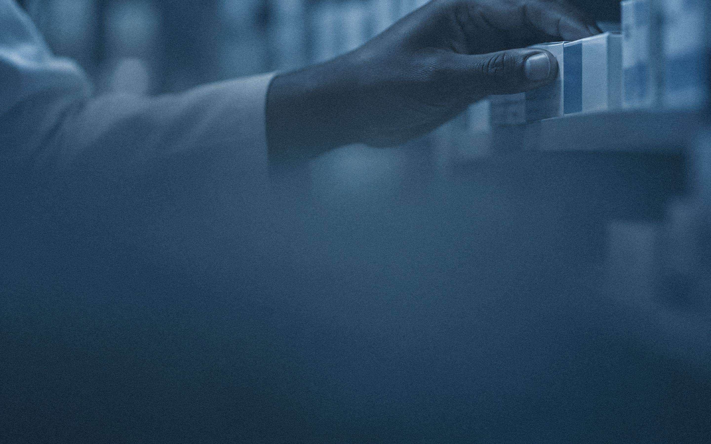 Pharmacist reaching for a product on a shelf