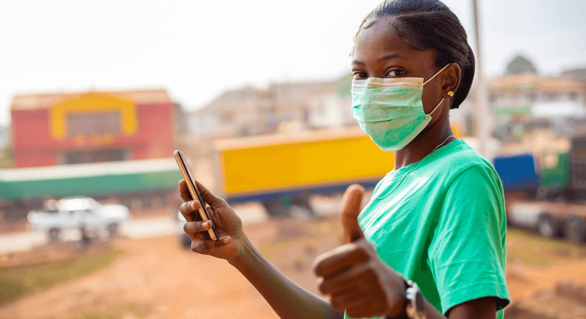 Young woman verifying information on her phone at a market